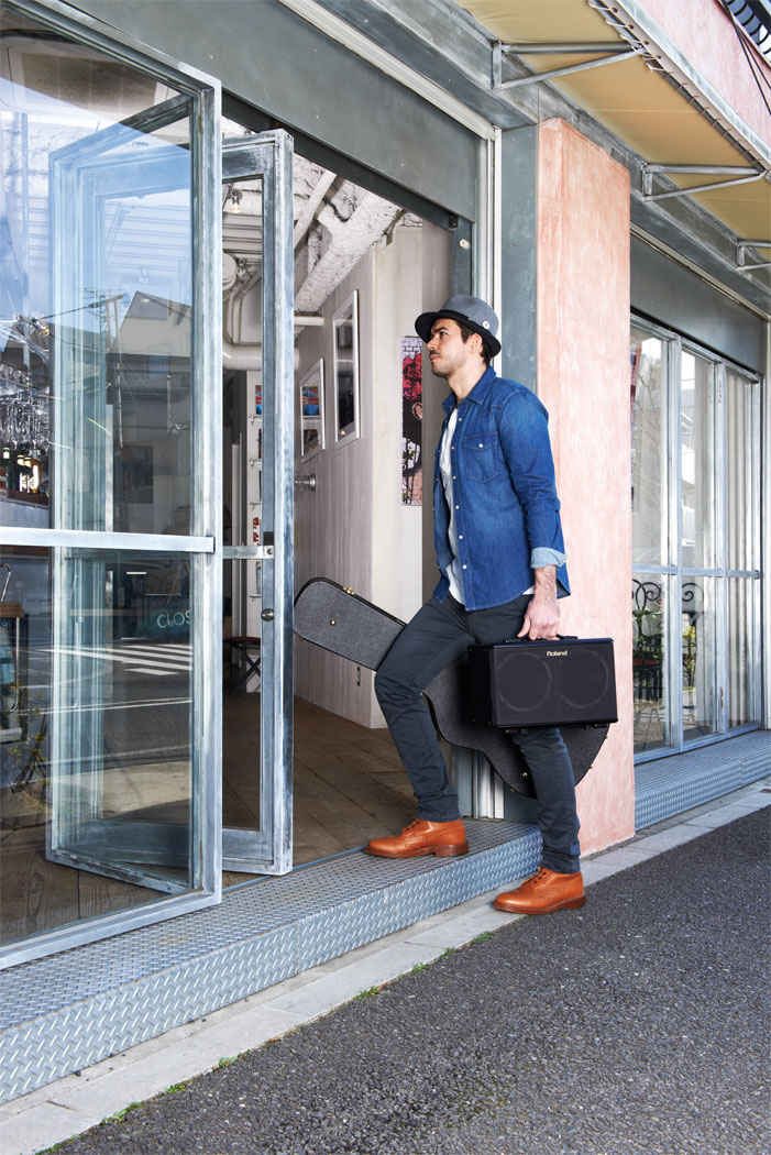 Performing carrying Roland AC-40.